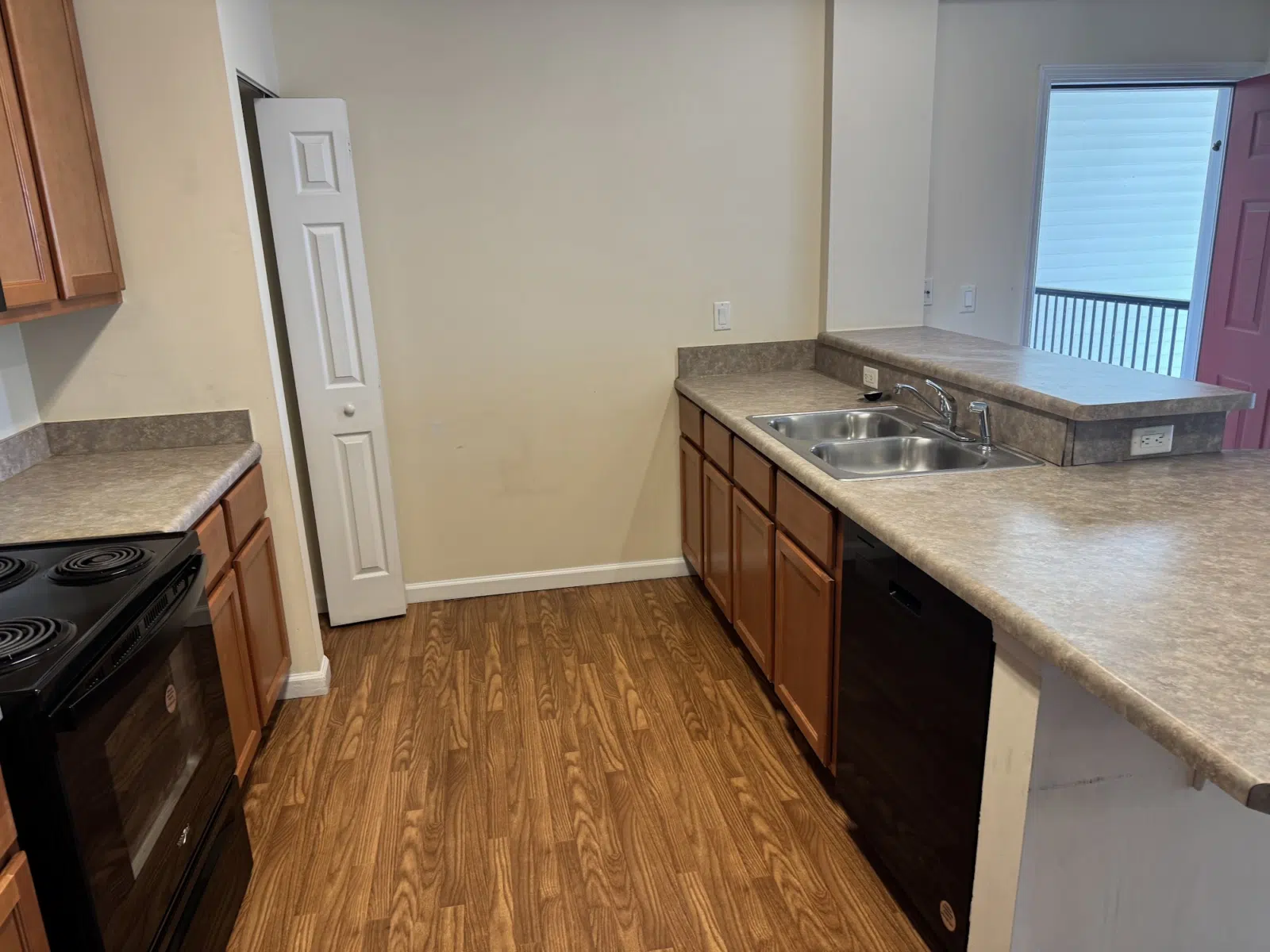 Empty cleaned kitchen with wood-look flooring and stone counters — Leskuin Cleaning LLC in Springfield