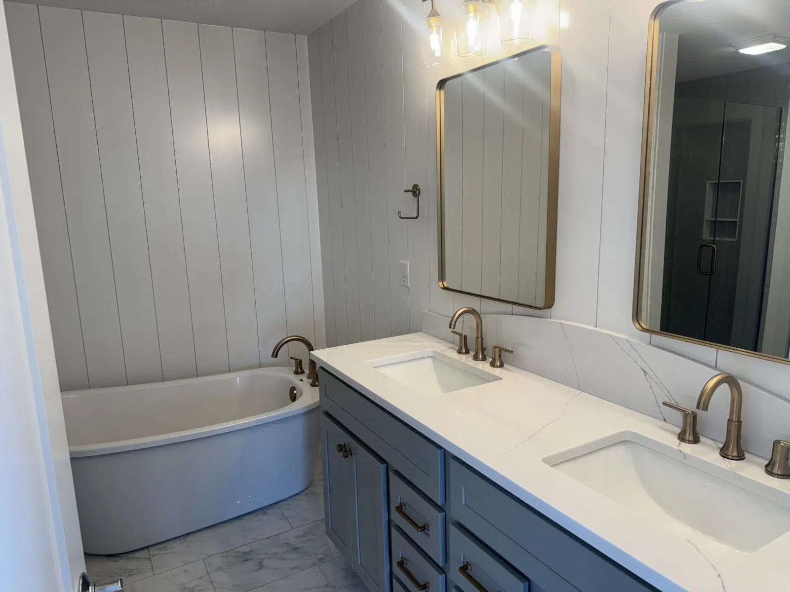 Bright remodeled bathroom with double vanity and freestanding tub — Leskuin Cleaning LLC in Springfield